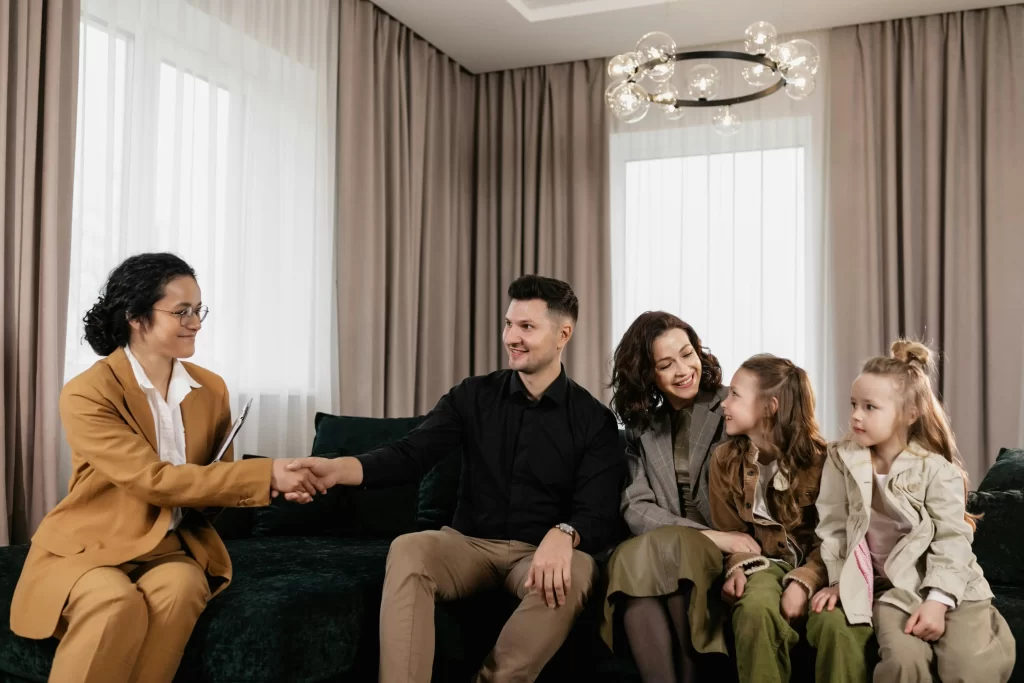 Family sitting together on a couch, symbolizing trust and confidentiality agreements in childcare.